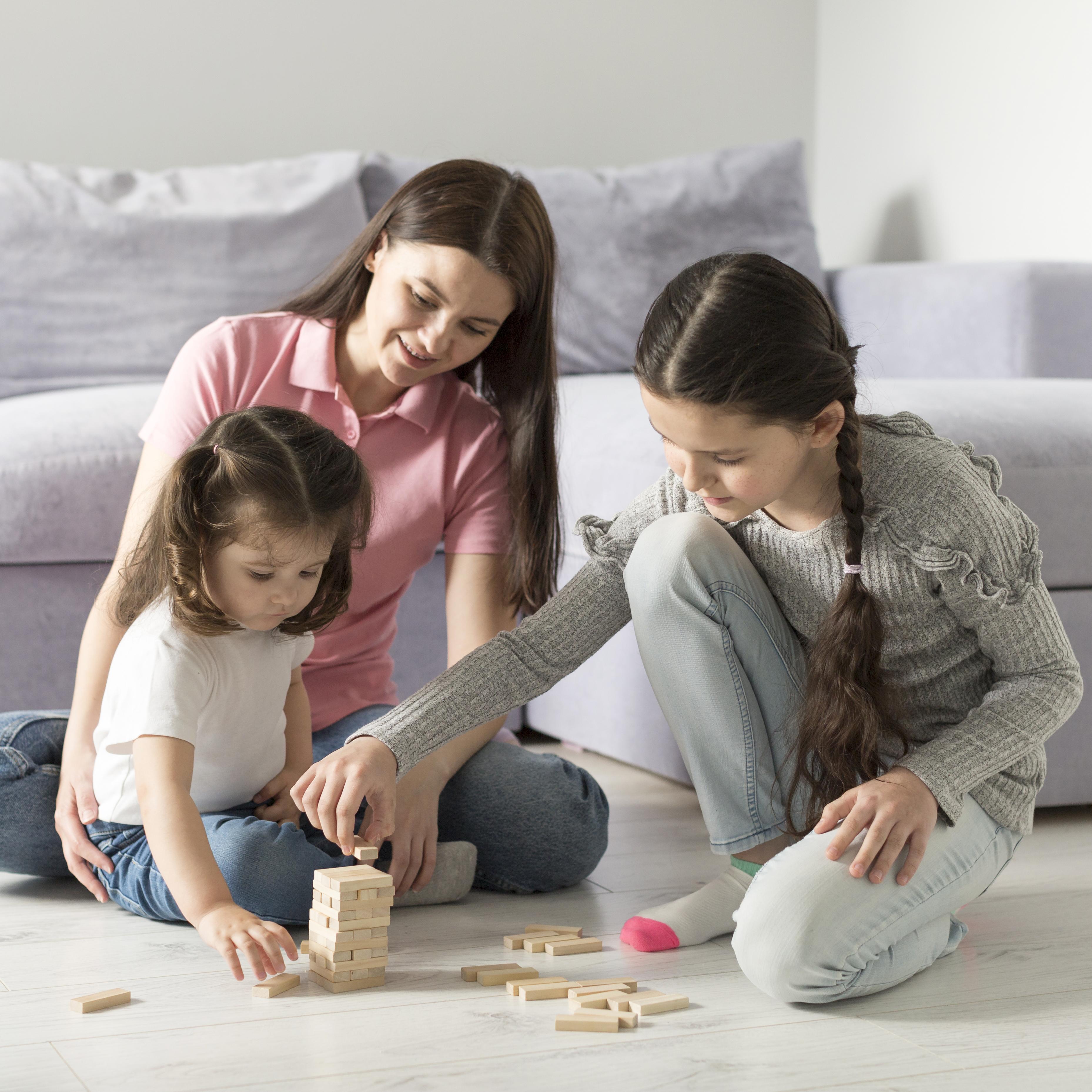 A teacher and child engaged in floor play — the SEED approach to early childhood education
